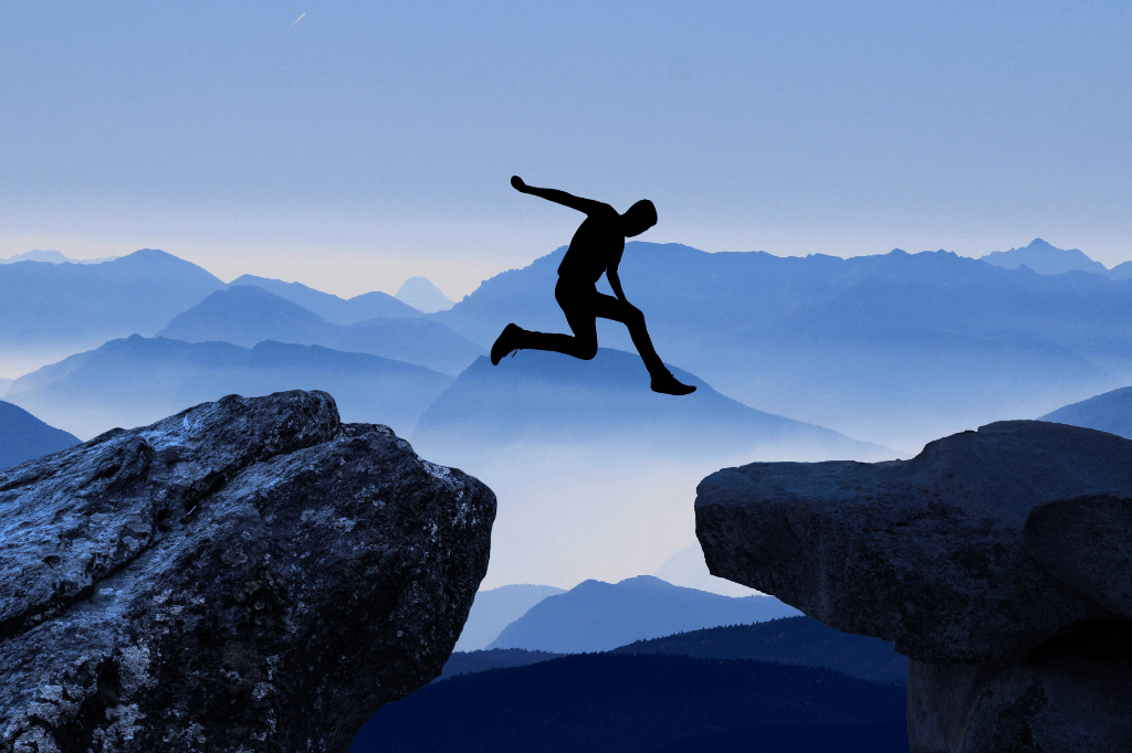 man jumping over mountain